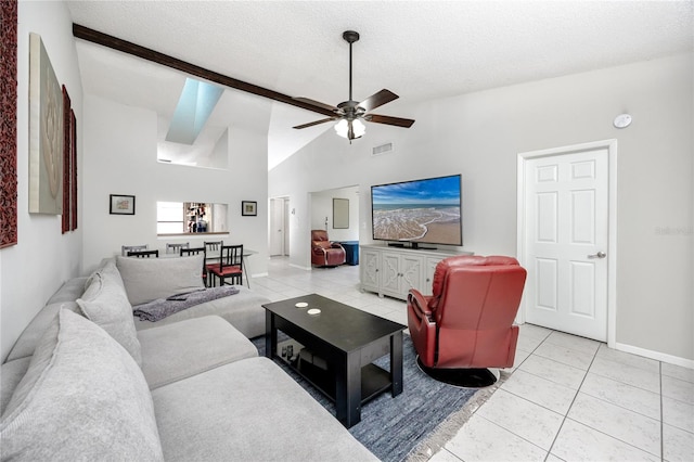 living room featuring ceiling fan, high vaulted ceiling, a textured ceiling, and light tile patterned flooring