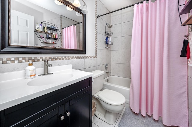 full bathroom featuring shower / bath combination with curtain, toilet, tile patterned floors, tile walls, and vanity