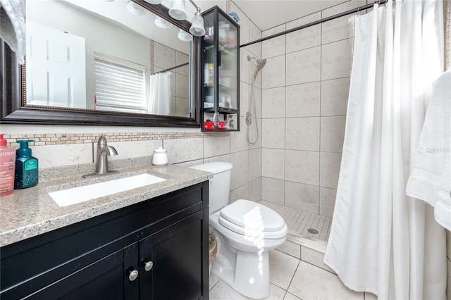 bathroom with tile patterned floors, toilet, backsplash, curtained shower, and vanity