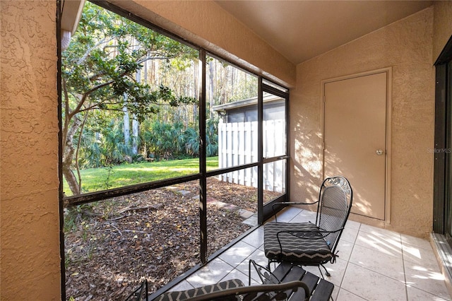 sunroom featuring vaulted ceiling