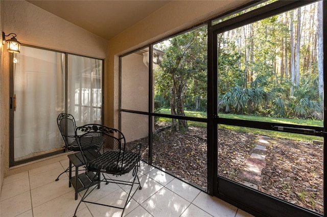 sunroom featuring vaulted ceiling