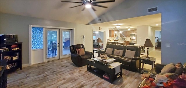 living room featuring french doors, ceiling fan, high vaulted ceiling, and wood-type flooring