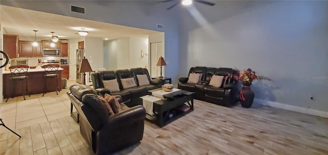 living room featuring light hardwood / wood-style flooring and ceiling fan