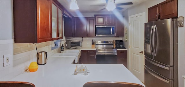 kitchen featuring ceiling fan, tasteful backsplash, appliances with stainless steel finishes, and sink