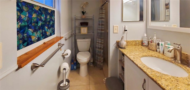 bathroom with vanity, toilet, and tile patterned floors