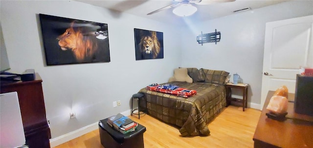 bedroom with ceiling fan and wood-type flooring