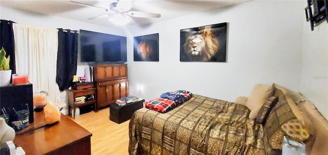 bedroom with hardwood / wood-style floors and ceiling fan