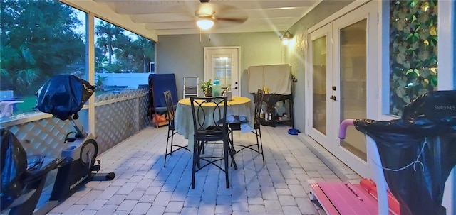 sunroom / solarium with french doors, beam ceiling, and ceiling fan