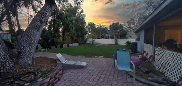 yard at dusk featuring a patio area