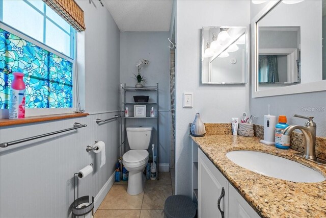 1467 Monte St, Port Charlotte, FL 33952 - bathroom with toilet, tile patterned flooring, and vanity
