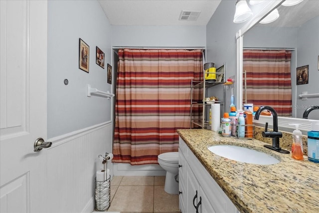 1467 Monte St, Port Charlotte, FL 33952 - bathroom with tile patterned floors, a shower with shower curtain, toilet, vanity, and wainscoting
