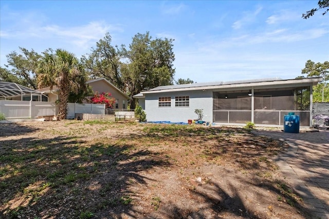 1467 Monte St, Port Charlotte, FL 33952 - rear view of property with a sunroom, fence, and stucco siding