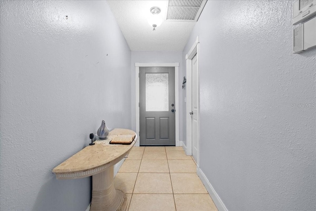1467 Monte St, Port Charlotte, FL 33952 - doorway with light tile patterned flooring, baseboards, and a textured wall