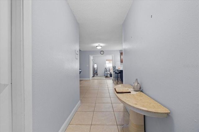 1467 Monte St, Port Charlotte, FL 33952 - corridor with light tile patterned flooring, baseboards, and a textured ceiling