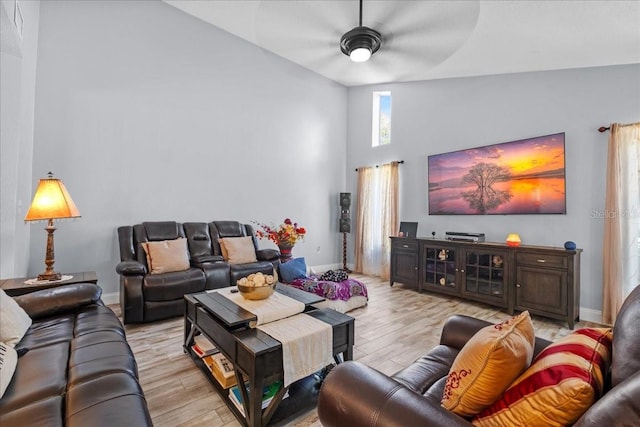 1467 Monte St, Port Charlotte, FL 33952 - living area featuring light wood-style floors, a ceiling fan, high vaulted ceiling, and baseboards