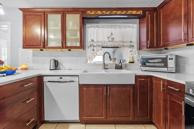 1467 Monte St, Port Charlotte, FL 33952 - kitchen with white dishwasher, a sink, backsplash, and light countertops