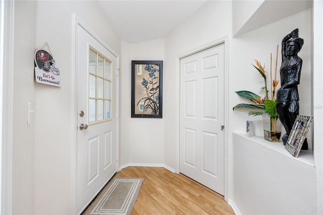 entryway featuring a textured ceiling and light wood-type flooring