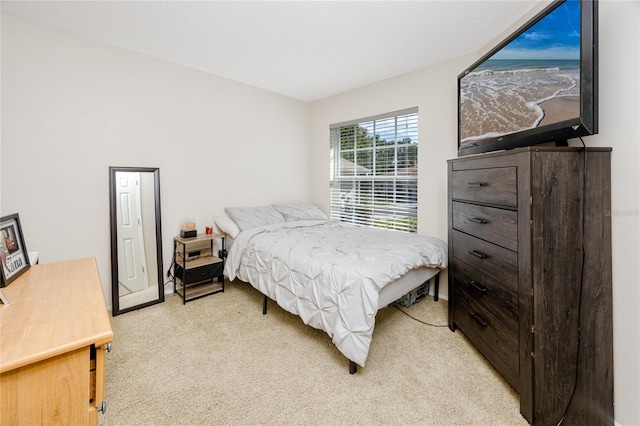 bedroom featuring light carpet