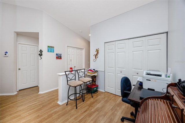 office space featuring lofted ceiling and light wood-type flooring