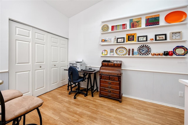 office area with light hardwood / wood-style floors and vaulted ceiling