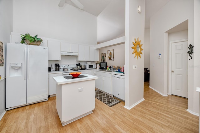 kitchen with a center island, light hardwood / wood-style flooring, white appliances, and white cabinets