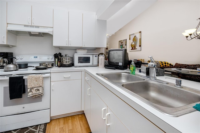 kitchen featuring lofted ceiling, hanging light fixtures, light wood-type flooring, white cabinetry, and white appliances