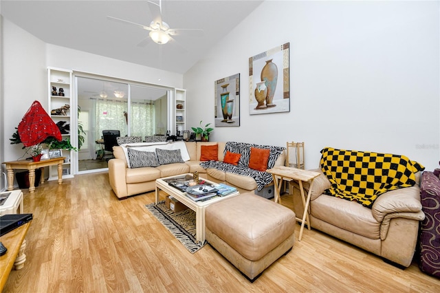 living room with hardwood / wood-style floors, vaulted ceiling, and ceiling fan