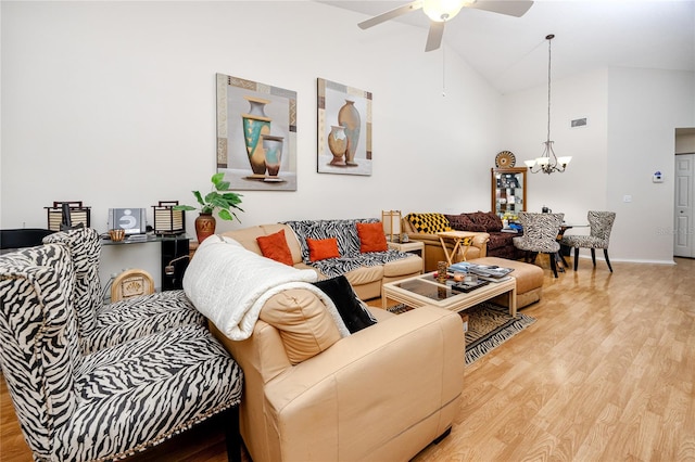 living room featuring light hardwood / wood-style flooring, high vaulted ceiling, and ceiling fan with notable chandelier