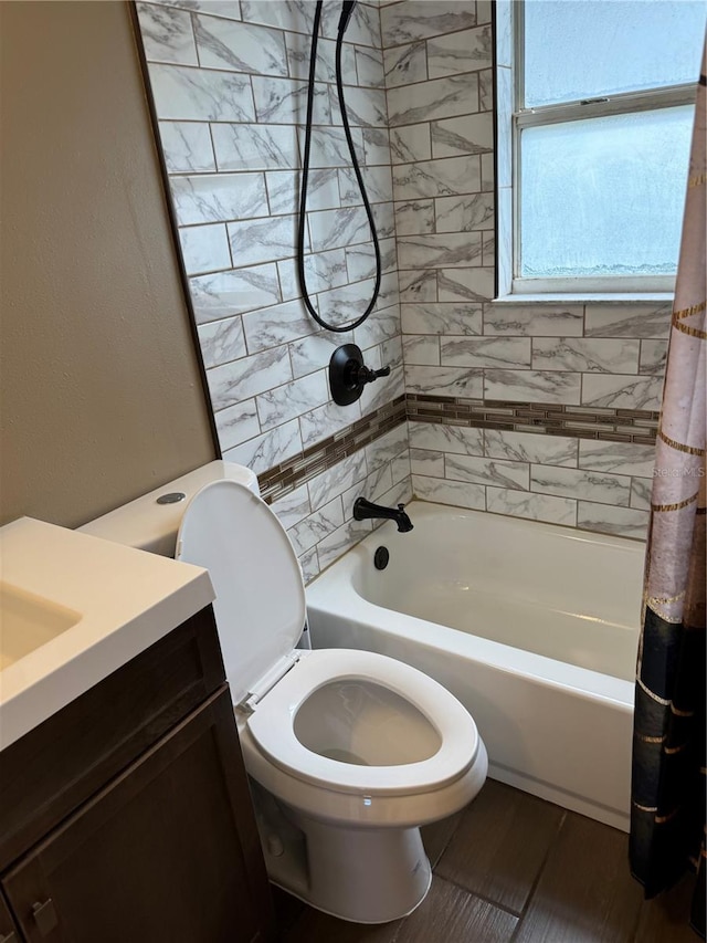 full bathroom with hardwood / wood-style floors, vanity, shower / bath combo, and toilet