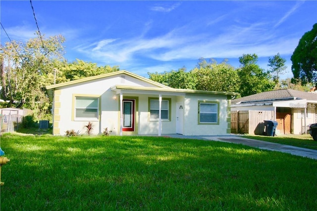 view of front of house featuring a front yard and central AC unit