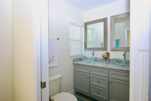 bathroom featuring vanity and toilet