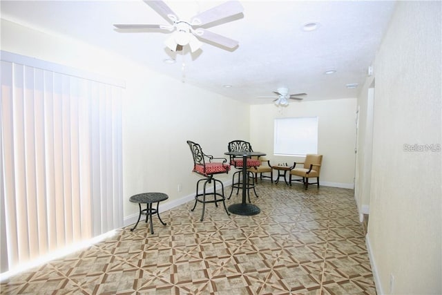 living area with ceiling fan