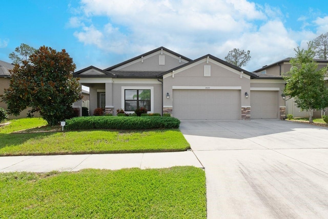 view of front of home with a front yard and a garage