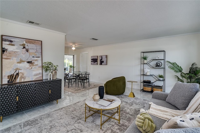 living room featuring ornamental molding, a textured ceiling, and ceiling fan