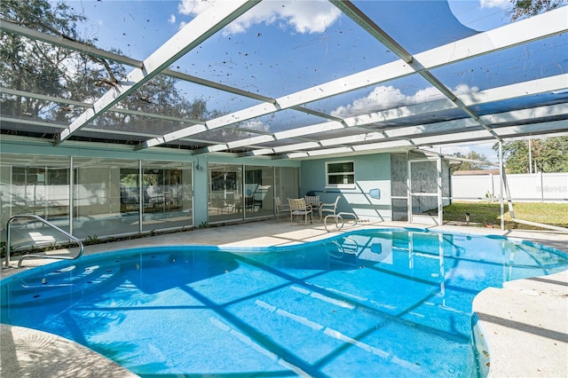 view of swimming pool with a patio and a lanai