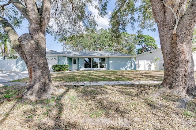 ranch-style home featuring a front yard