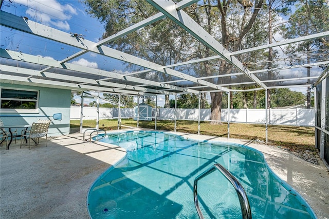 view of swimming pool with a patio and a lanai