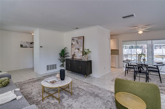 living room with crown molding and ceiling fan