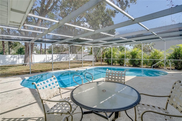 view of swimming pool with a patio area and glass enclosure