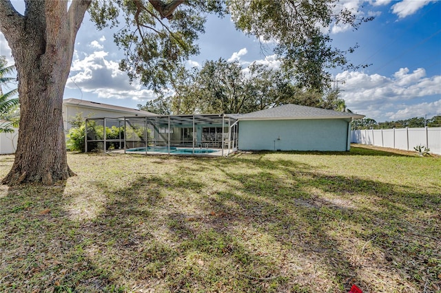 view of yard featuring a fenced in pool and a lanai