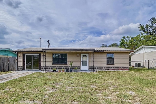 view of front of property with a front yard and central air condition unit