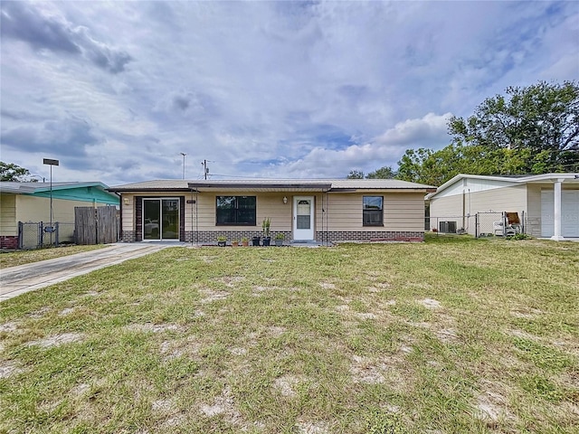 manufactured / mobile home with central air condition unit and a front lawn