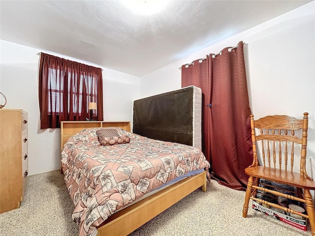 carpeted bedroom featuring a textured ceiling