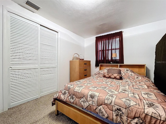 carpeted bedroom with a textured ceiling