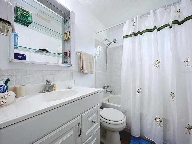 full bathroom with vanity, shower / bath combo with shower curtain, toilet, and tile walls