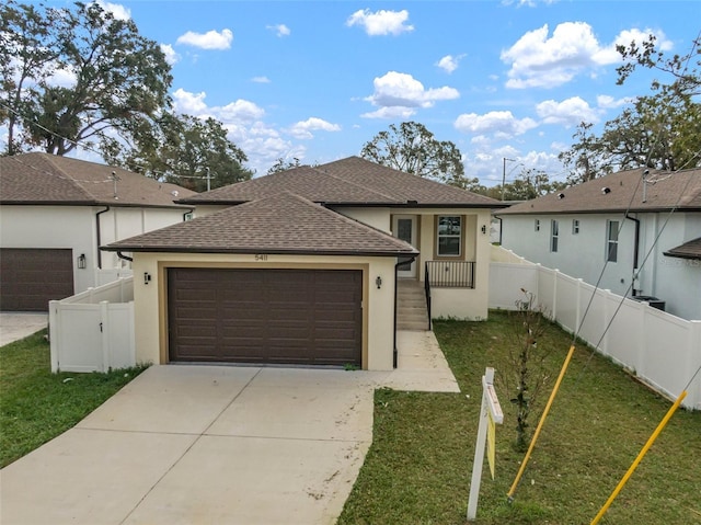 view of front of property with a garage and a front lawn