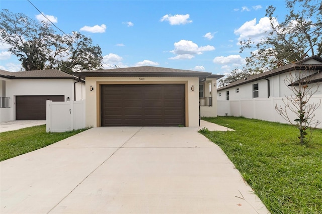 view of front of home with a garage and a front lawn