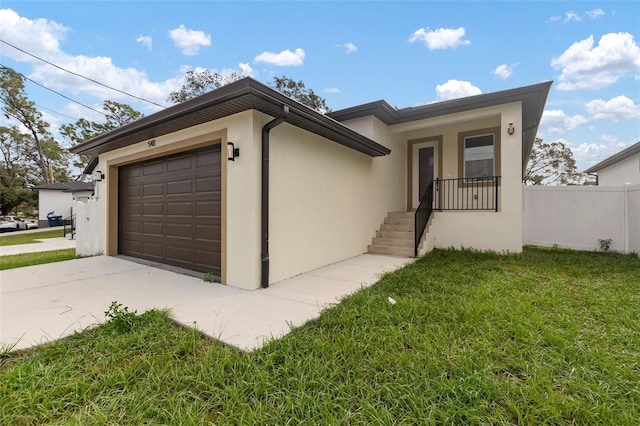 view of front of house with a garage and a front yard