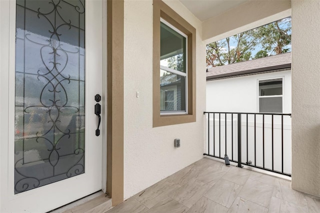 doorway to property featuring a balcony