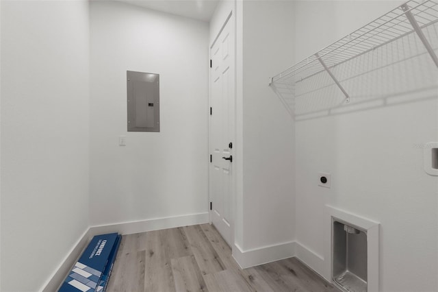 laundry area with electric panel, light wood-type flooring, and electric dryer hookup